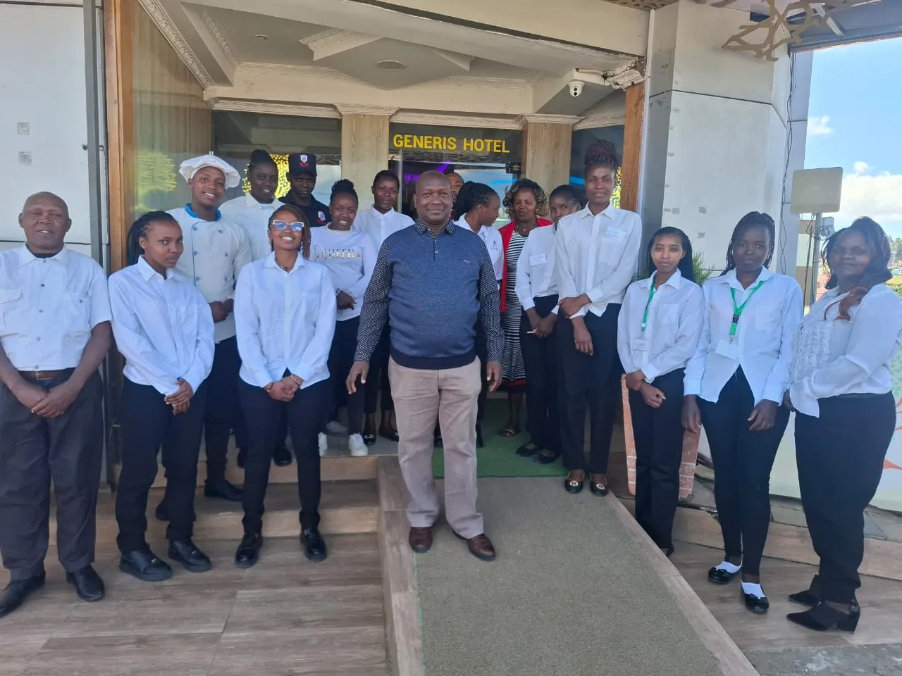 The Generis Hotel team outside the hotel entrance in Molo — reception, restaurant, housekeeping and kitchen staff